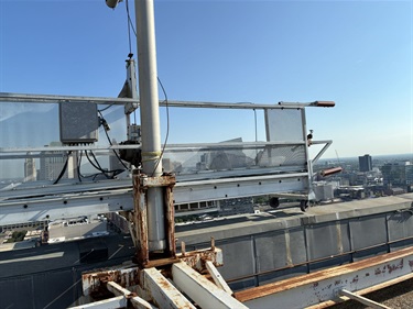 old-window-washer-access-on-roof-where-screens-are-falling-off.jpg